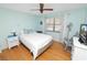 Cozy bedroom features hardwood floors, light blue walls, and a ceiling fan for added comfort at 2025 Sylvester Rd # E2, Lakeland, FL 33803