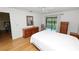 Bright bedroom with hardwood floors, a queen bed, and a sliding glass door leading to a sunroom at 2025 Sylvester Rd # E2, Lakeland, FL 33803