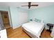 Light-filled bedroom with hardwood floors, pale blue walls, closet, and natural light at 2025 Sylvester Rd # E2, Lakeland, FL 33803