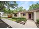 Inviting home showcasing well-maintained landscaping and a red front door, adding a touch of warmth and character at 2025 Sylvester Rd # E2, Lakeland, FL 33803