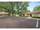 Townhome boasts mature trees, manicured landscaping, and ample parking, creating a welcoming exterior at 2025 Sylvester Rd # E2, Lakeland, FL 33803