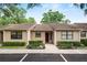 Charming townhome featuring manicured landscaping, a brick entryway, and ample parking at 2025 Sylvester Rd # E2, Lakeland, FL 33803
