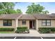 Charming home featuring a red front door and manicured landscaping, creating a welcoming curb appeal at 2025 Sylvester Rd # E2, Lakeland, FL 33803