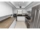 Efficient kitchen with white cabinets, a stainless steel refrigerator, and track lighting at 2025 Sylvester Rd # E2, Lakeland, FL 33803