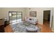 Bright living room with hardwood floors, a sofa, and sliding glass doors at 2025 Sylvester Rd # E2, Lakeland, FL 33803