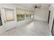 The sunroom has a ceiling fan, tile flooring, and ample natural light via windows and sliding glass doors at 2025 Sylvester Rd # E2, Lakeland, FL 33803
