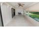 Sunroom features tile flooring, a ceiling fan, a workspace and views to the backyard and through sliding glass doors at 2025 Sylvester Rd # E2, Lakeland, FL 33803