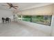 Sunroom featuring tile flooring, a ceiling fan, and large windows providing views of the backyard at 2025 Sylvester Rd # E2, Lakeland, FL 33803