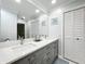 Bathroom featuring double sinks, white countertops, and traditional style cabinetry at 203 N Sweetwater Blvd, Longwood, FL 32779