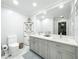 Bathroom featuring double sinks, marble countertops, and an elegant mirror for a luxurious feel at 203 N Sweetwater Blvd, Longwood, FL 32779