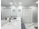 Well-lit bathroom with double vanity, marble countertops, and ample cabinet space for a comfortable experience at 203 N Sweetwater Blvd, Longwood, FL 32779