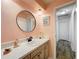 Charming bathroom shows a round mirror, painted walls, and modern vanity at 203 N Sweetwater Blvd, Longwood, FL 32779