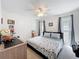 Bright bedroom with seashell accents, two windows, and neutral carpet offers a cozy retreat at 203 N Sweetwater Blvd, Longwood, FL 32779