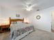 Bright bedroom with a decorative bed frame, wooden nightstands, and neutral-toned carpet at 203 N Sweetwater Blvd, Longwood, FL 32779