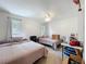 Bright bedroom features two beds, neutral walls, and ample natural light at 203 N Sweetwater Blvd, Longwood, FL 32779