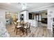 Open dining area features a modern table set, wood floors, and seamless flow into living spaces and kitchen at 203 N Sweetwater Blvd, Longwood, FL 32779