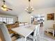 Elegant dining room featuring a chandelier, ample seating, and stylish decor at 203 N Sweetwater Blvd, Longwood, FL 32779
