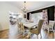 Elegant dining room featuring a chandelier, ample seating, and stylish decor at 203 N Sweetwater Blvd, Longwood, FL 32779