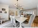 Elegant dining room featuring a chandelier, ample seating, and stylish decor at 203 N Sweetwater Blvd, Longwood, FL 32779