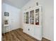 Foyer with hardwood floors, a decorative display cabinet, and a view of the front door at 203 N Sweetwater Blvd, Longwood, FL 32779