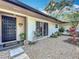 Inviting front entrance with a decorative door, stone landscaping, and a welcoming ambiance at 203 N Sweetwater Blvd, Longwood, FL 32779