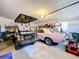 Garage showcasing a golf cart and classic car with ample storage and workspace at 203 N Sweetwater Blvd, Longwood, FL 32779