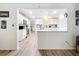 Open concept kitchen boasts white cabinetry, granite countertops, and modern appliances at 203 N Sweetwater Blvd, Longwood, FL 32779
