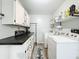 Bright laundry room with modern appliances, counter space, and storage for convenient home management at 203 N Sweetwater Blvd, Longwood, FL 32779
