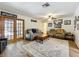 Cozy living room with French doors, ceiling fan, and a neutral rug offers a comfortable gathering space at 203 N Sweetwater Blvd, Longwood, FL 32779