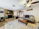 Living room with brick fireplace, Gathering decor, and French doors to patio provides a warm, inviting ambiance at 203 N Sweetwater Blvd, Longwood, FL 32779