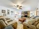 This comfortable living room features a brick fireplace, mounted TV, and open access to the kitchen at 203 N Sweetwater Blvd, Longwood, FL 32779