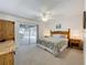 Bright main bedroom features sliding glass doors to the pool area and neutral decor at 203 N Sweetwater Blvd, Longwood, FL 32779