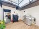 Outdoor kitchen with a built-in grill, wooden deck, and a pergola for shade at 203 N Sweetwater Blvd, Longwood, FL 32779
