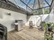 Covered outdoor kitchen with a grill and comfortable seating, ideal for outdoor entertaining at 203 N Sweetwater Blvd, Longwood, FL 32779