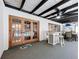 Covered patio with bar area adjacent to the pool, featuring comfortable seating and stylish decor at 203 N Sweetwater Blvd, Longwood, FL 32779