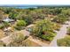 Aerial view of a home nestled among lush trees, showcasing its serene setting and proximity to the lake at 209 S Hydrangea Ave, Polk City, FL 33868