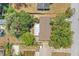 Aerial view of a home with a long, brown roof, showcasing its spacious lot, and surrounding greenery at 209 S Hydrangea Ave, Polk City, FL 33868