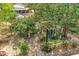 The backyard features a patio seating area amongst trees and foliage for relaxation and outdoor enjoyment at 209 S Hydrangea Ave, Polk City, FL 33868