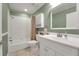 A classic bathroom with a shower-tub combination, white vanity, and green walls, perfect for relaxation at 209 S Hydrangea Ave, Polk City, FL 33868