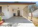 Open carport featuring door entrance, lattice work and adjacent lawn at 209 S Hydrangea Ave, Polk City, FL 33868