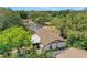 A cozy home with a brown roof and a charming, well-maintained yard nestled among lush greenery at 209 S Hydrangea Ave, Polk City, FL 33868
