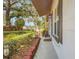 Side view of home showcasing landscaped yard, plants and the building's facade at 209 S Hydrangea Ave, Polk City, FL 33868