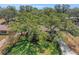An inviting home framed by mature trees and a verdant lawn, offering a serene and picturesque setting at 209 S Hydrangea Ave, Polk City, FL 33868