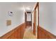 Hallway with wood trim and hardwood floors, connecting different areas of the home with charm at 209 S Hydrangea Ave, Polk City, FL 33868