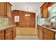 Open kitchen overlooking dining area features granite countertops and hardwood floors, perfect for entertaining at 209 S Hydrangea Ave, Polk City, FL 33868