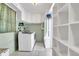 Functional laundry room with washer, dryer, and ample storage space, providing convenience for daily chores at 209 S Hydrangea Ave, Polk City, FL 33868