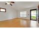 Bright living room with hardwood floors, a large window, and neutral paint, ready for personalization at 209 S Hydrangea Ave, Polk City, FL 33868