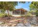 Cozy screened porch features ceiling fans, with access to a stone patio, providing a relaxing outdoor living space at 209 S Hydrangea Ave, Polk City, FL 33868