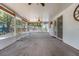 A spacious sunroom with ceiling fans, lots of windows, and cozy rugs, perfect for relaxation at 209 S Hydrangea Ave, Polk City, FL 33868