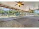 A bright sunroom with lots of windows, ceiling fans, and cozy rugs, perfect for relaxation and gatherings at 209 S Hydrangea Ave, Polk City, FL 33868